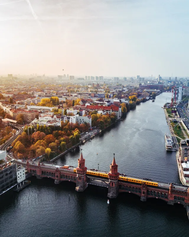 Aerial view of Berlin with view of Oberbaum bridge and yellow U-bahn on sunny autumn day